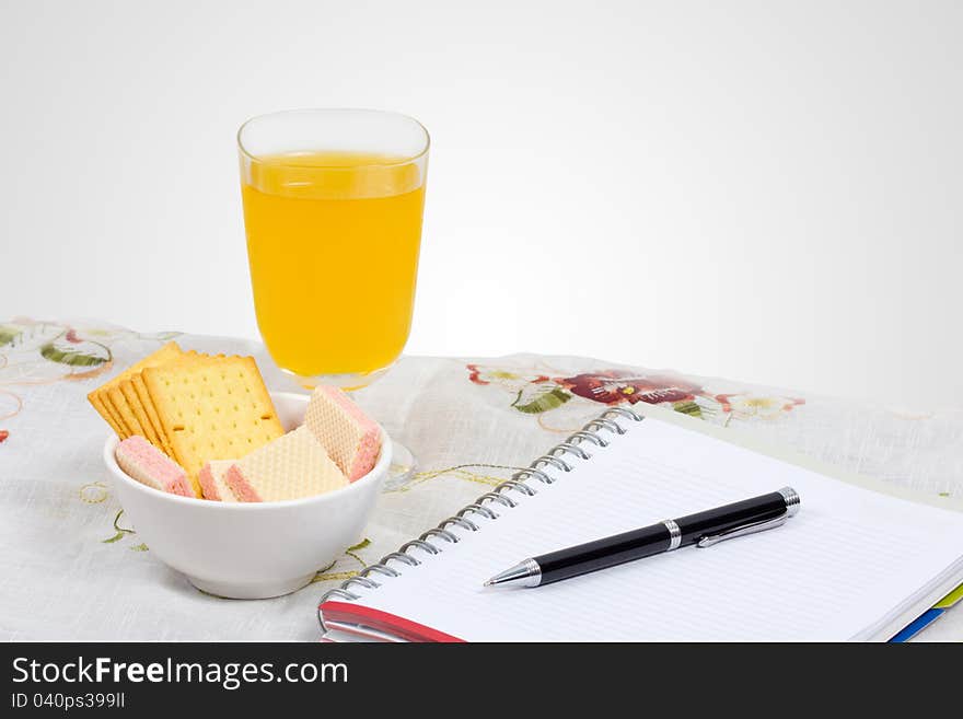 Wafer, cheese crackers and empty note book on a table. Wafer, cheese crackers and empty note book on a table.