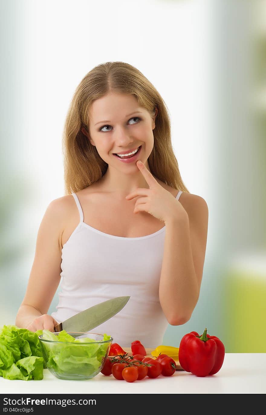 Fun happy young woman preparing vegetarian food, vegetables in the kitchen. Fun happy young woman preparing vegetarian food, vegetables in the kitchen