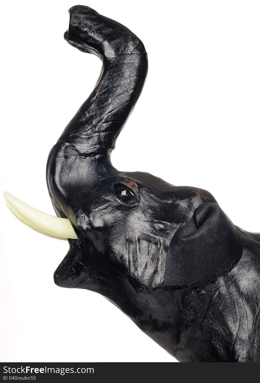 The head of a black leather elephant figurine against a white background. The head of a black leather elephant figurine against a white background