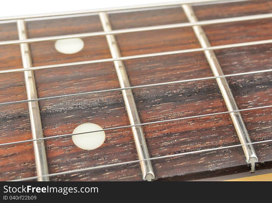 A close-up of an electric guitar fingerboard (fretboard) with strings. A close-up of an electric guitar fingerboard (fretboard) with strings