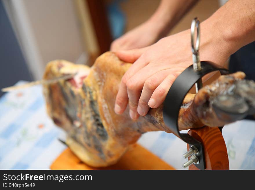 Waiter is slicing jamon at home. Waiter is slicing jamon at home.