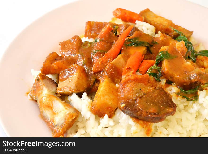 Stir fried crispy pork with red curry paste and rice. Stir fried crispy pork with red curry paste and rice