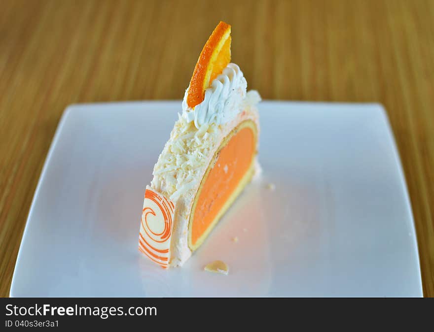 Orange ice cream cake with whipped cream