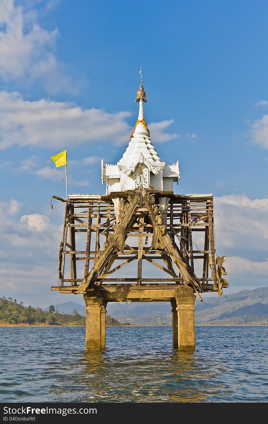 Part of Thai church bell tower expose in the river