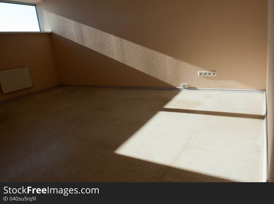 Picture of empty room with daylight flowing through the window and left  shadow on the floor. Picture of empty room with daylight flowing through the window and left  shadow on the floor