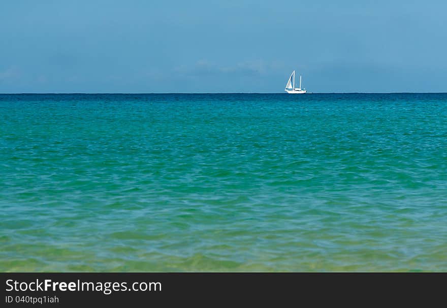 White sailboat on the azure sea