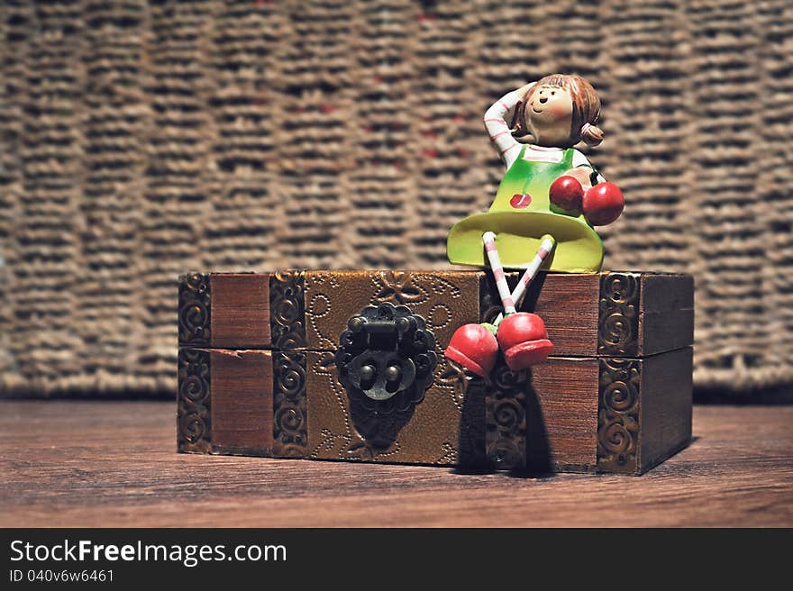 A doll on a wooden box