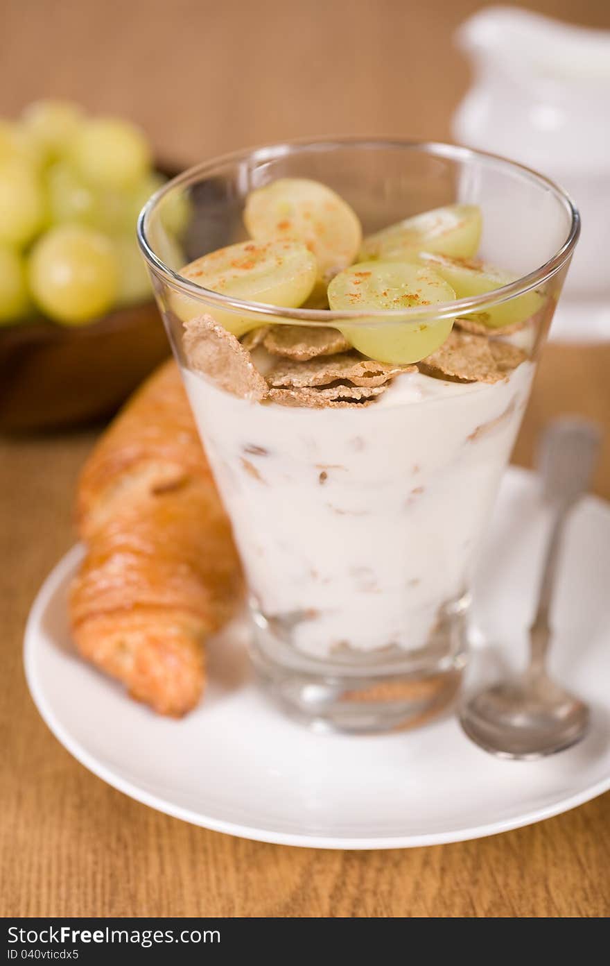 Delicious breakfast. Muesli, yoghurt, croissants and grapes