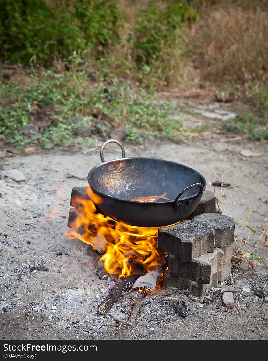 Frying fish in open