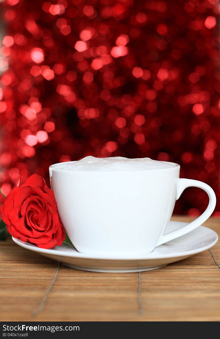 Image of a red rose on valentines day with a cup of coffee