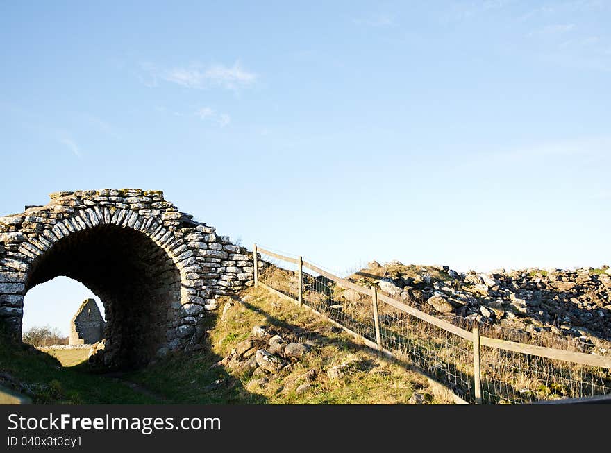 An old gateway into a stronghold ruin on the island Oland in Baltic Sea. An old gateway into a stronghold ruin on the island Oland in Baltic Sea