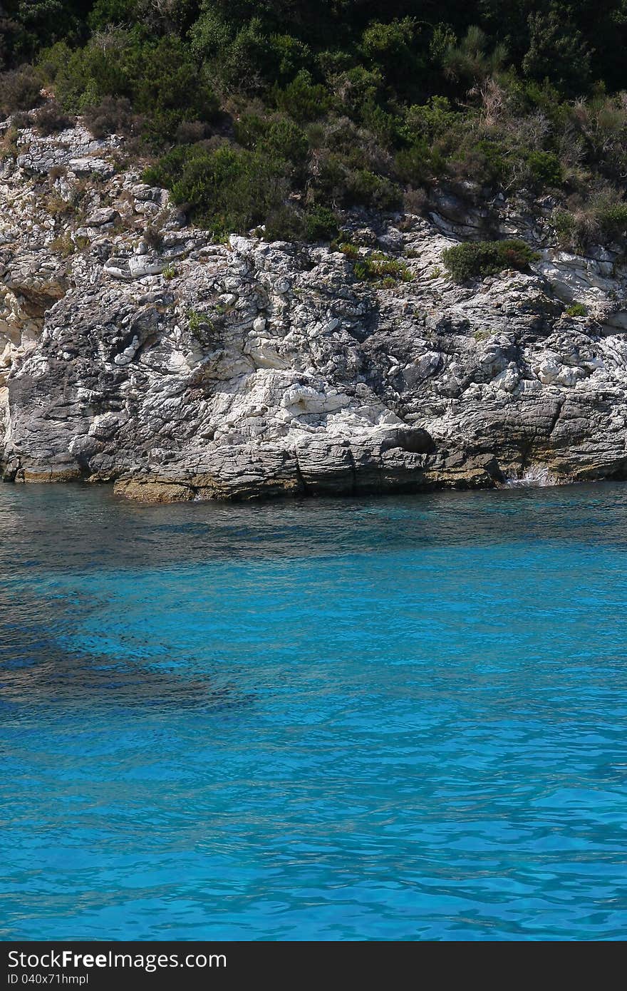 Rocky sea shore with amazing blue water. Rocky sea shore with amazing blue water