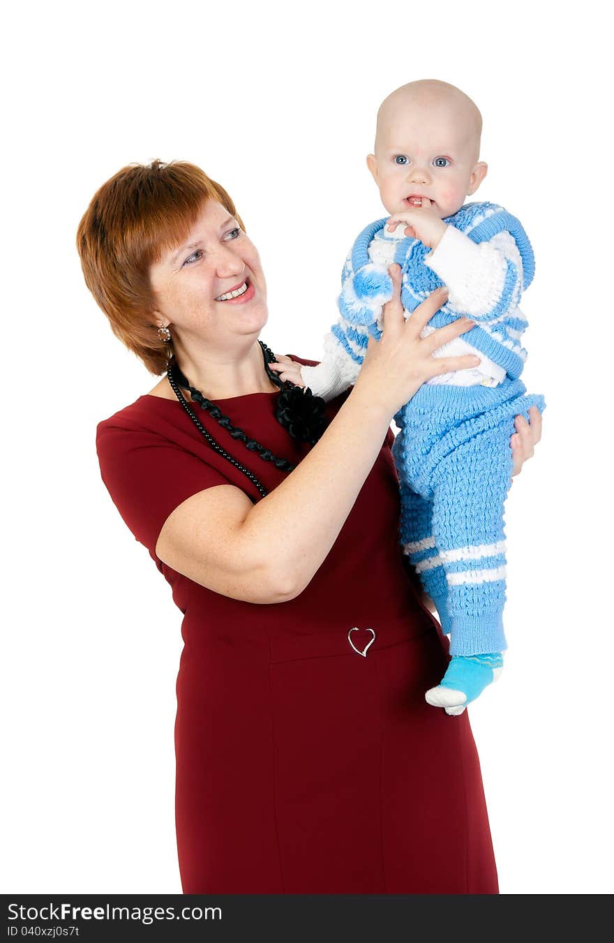 Grandmother with her grandson in her arms in the studio on a white background. Grandmother with her grandson in her arms in the studio on a white background