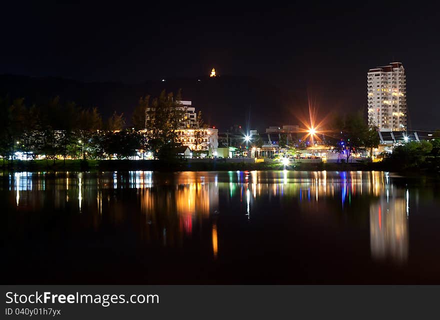 View the city at night, the reflection in the sea