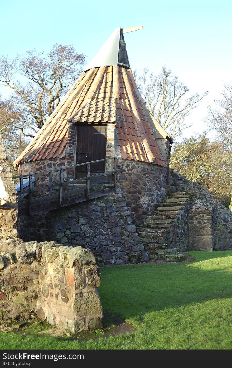 The Old Preston Mill at East Linton in East Lothian, Scotland showing tiled roof and entrance steps