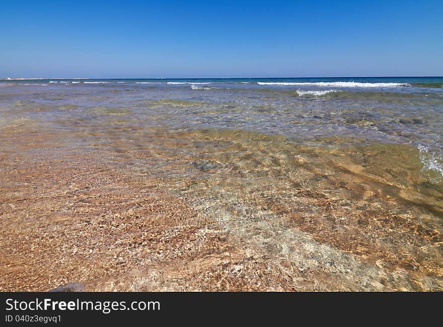 Tranquil sea water motion on a beach as background