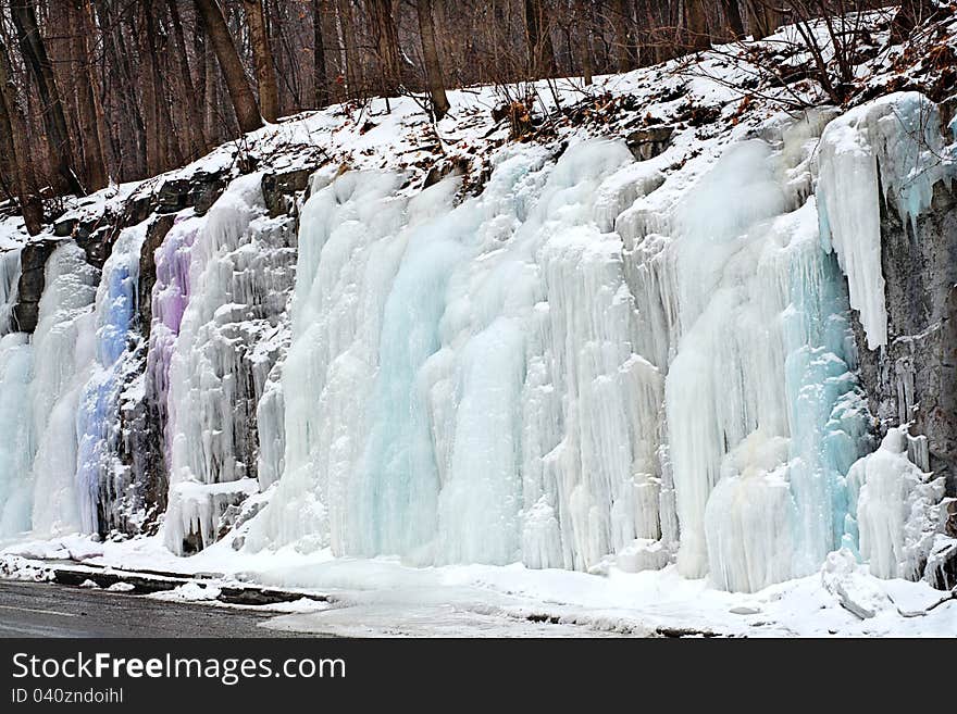 Icicles in pastel shades flowing over Mont Royal slope in Montreal, Quebec, Canada. Icicles in pastel shades flowing over Mont Royal slope in Montreal, Quebec, Canada