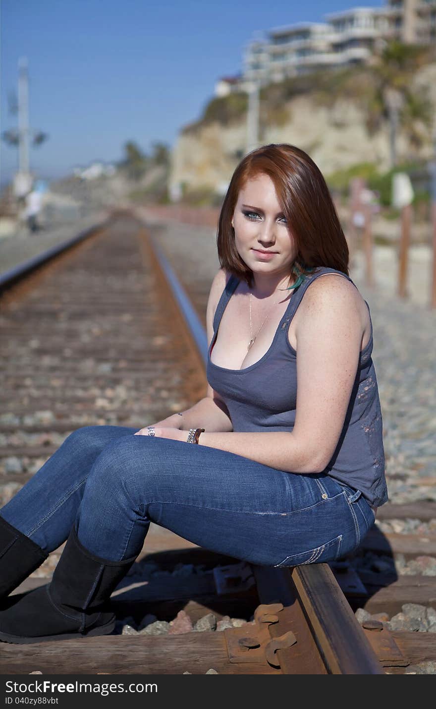 Cute Red Head Teen Girl sitting on Rail Road Tracks. Cute Red Head Teen Girl sitting on Rail Road Tracks