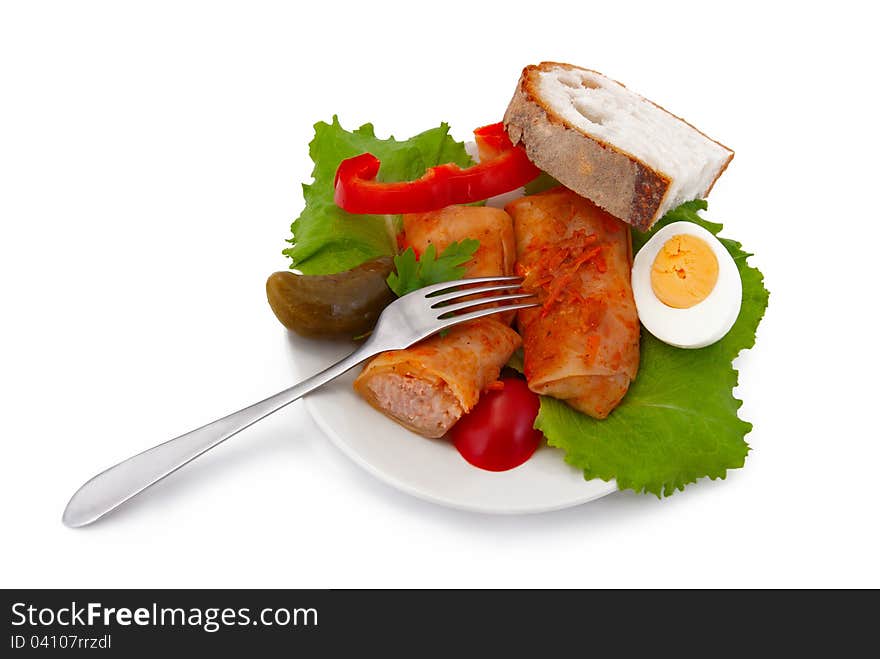 Stuffed cabbage on plate, fork and bread, isolated on white