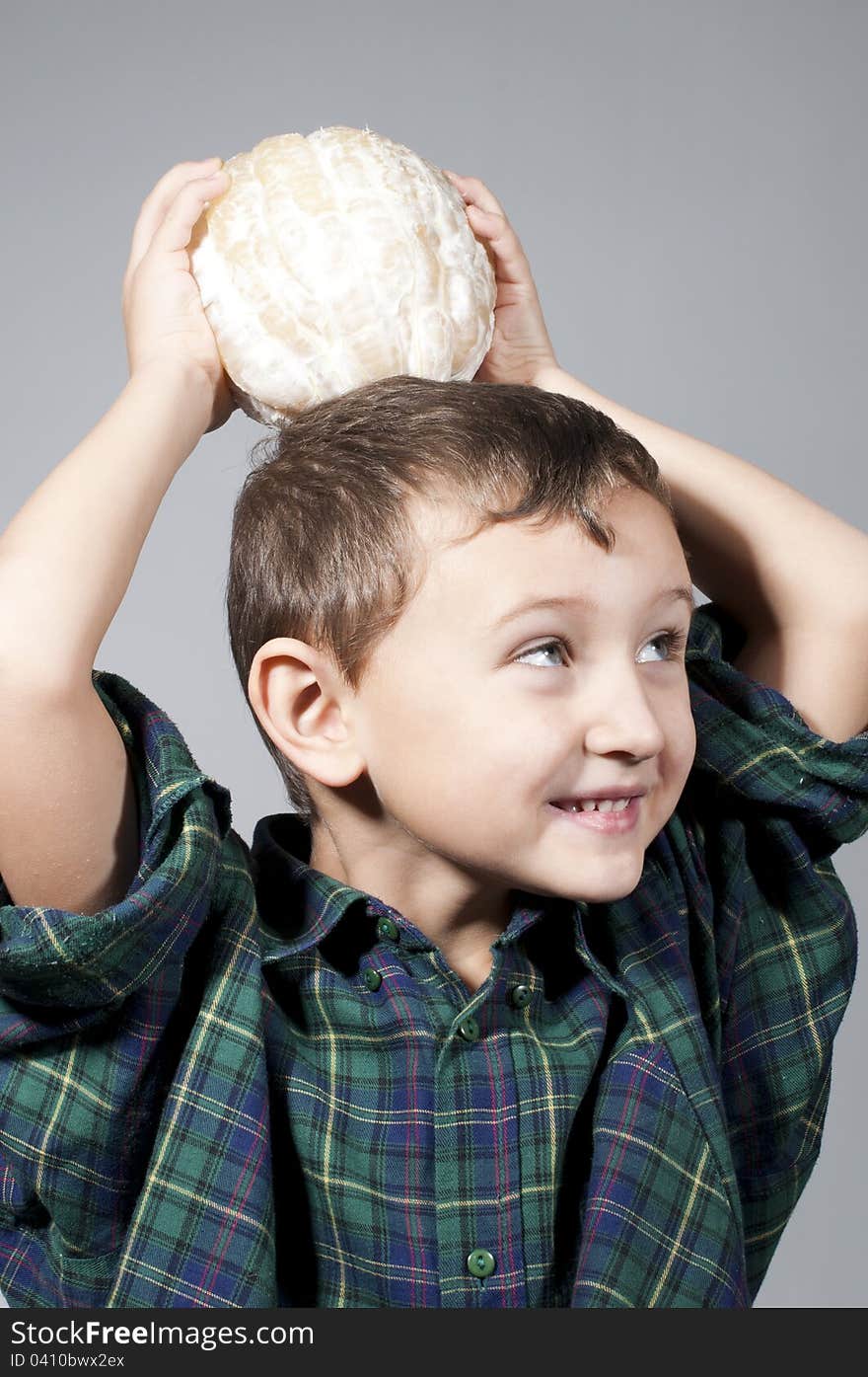 Little boy holding pomelo