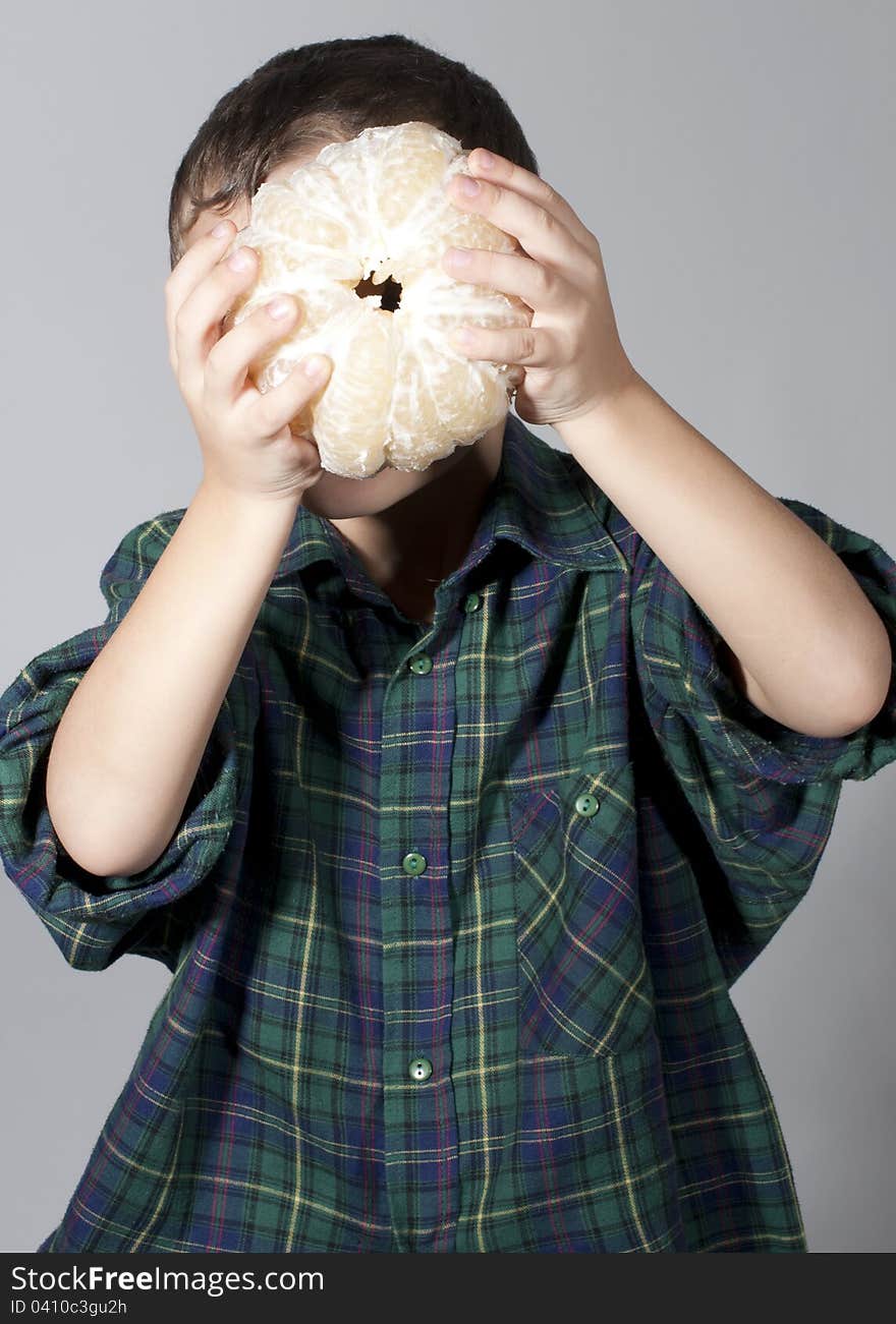 Little boy holding pomelo