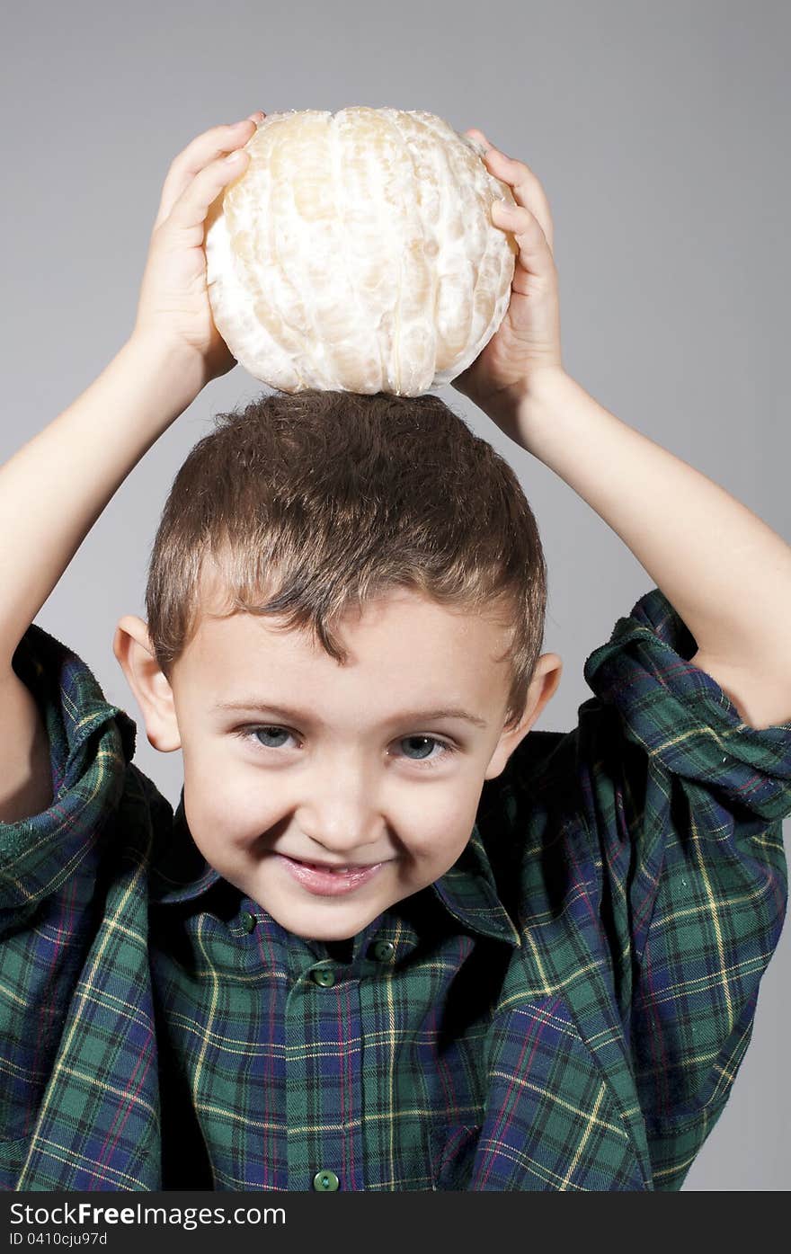 Little boy holding pomelo