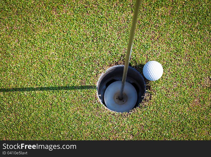 Golf ball very close to the hole