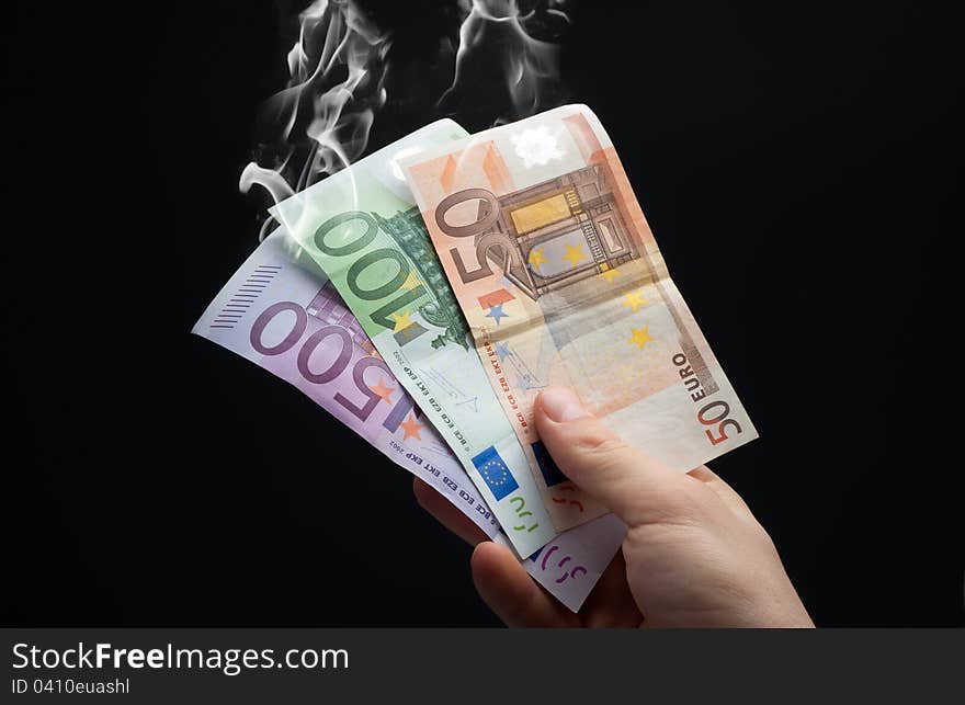 Hand taking euros to smoke