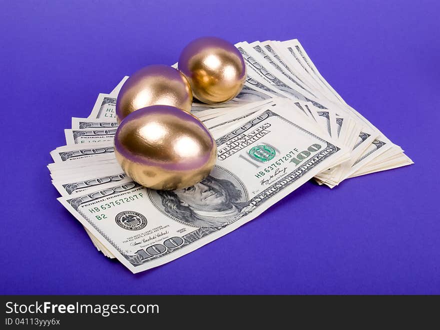 Golden eggs. A symbol of making money and successful investment on blue background