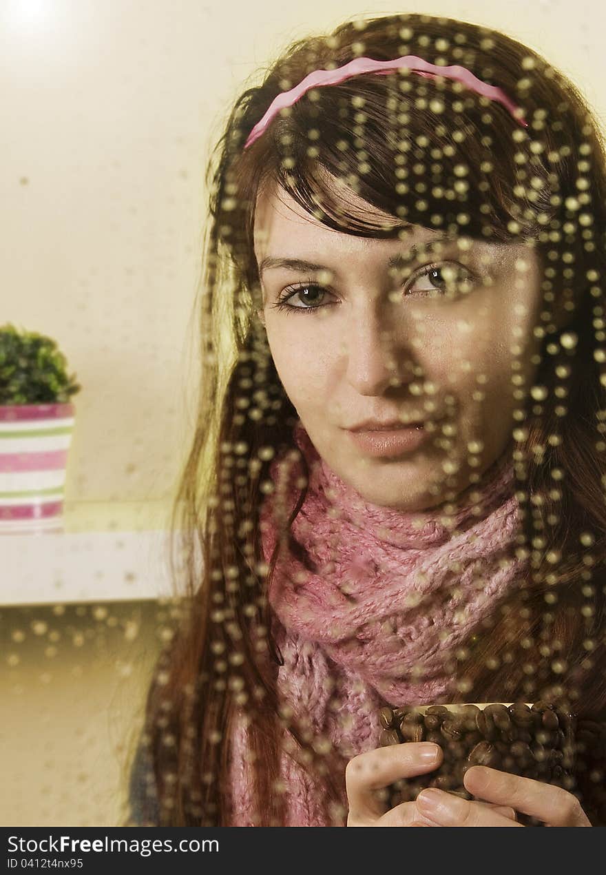 Young woman behind the glass drinking coffee. Young woman behind the glass drinking coffee