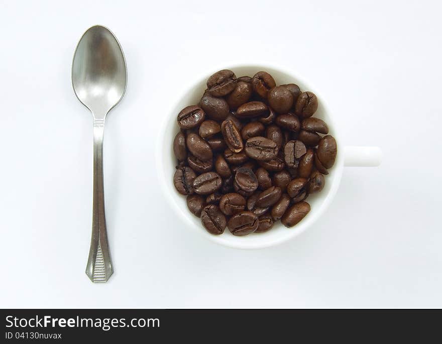 A cup with coffee beans. A cup with coffee beans