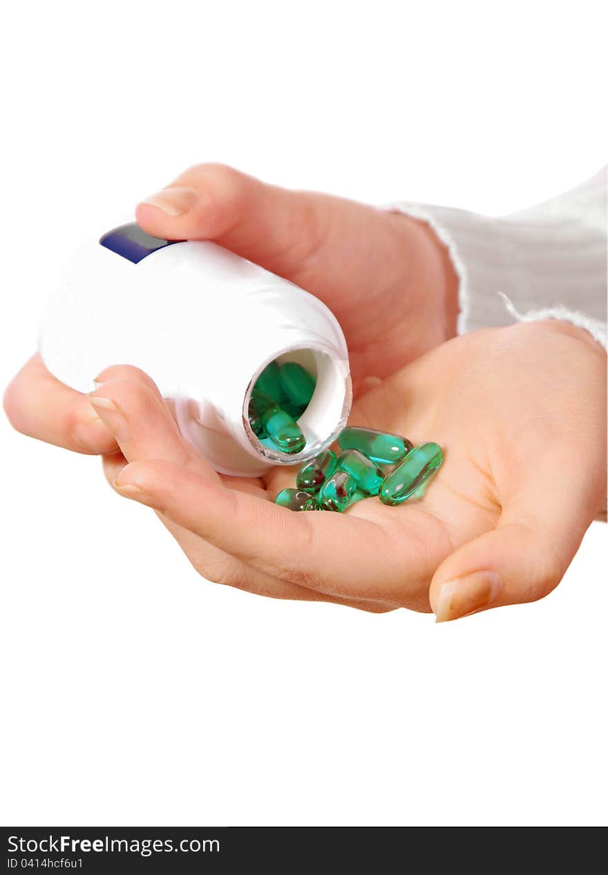 Female hand with medicine pills on white. Female hand with medicine pills on white