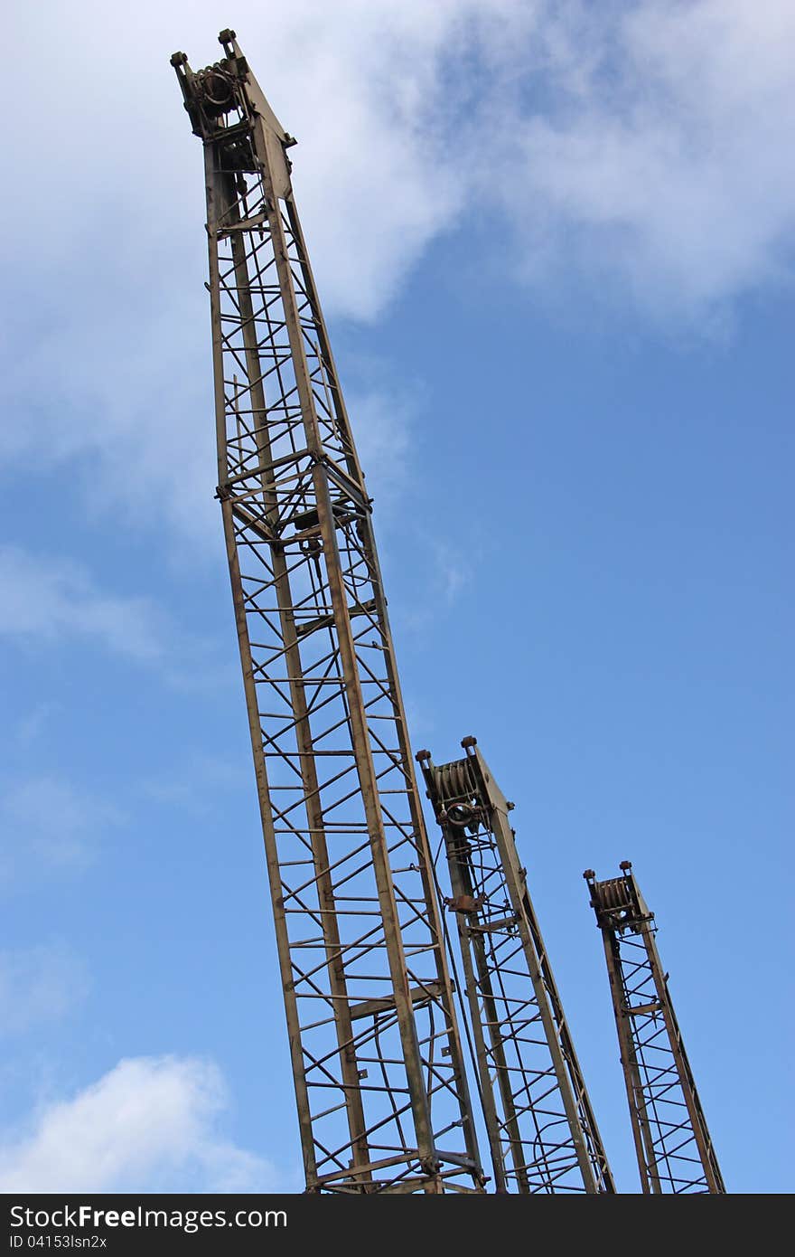 The Jibs of Three Vintage Cranes in a Line. The Jibs of Three Vintage Cranes in a Line.