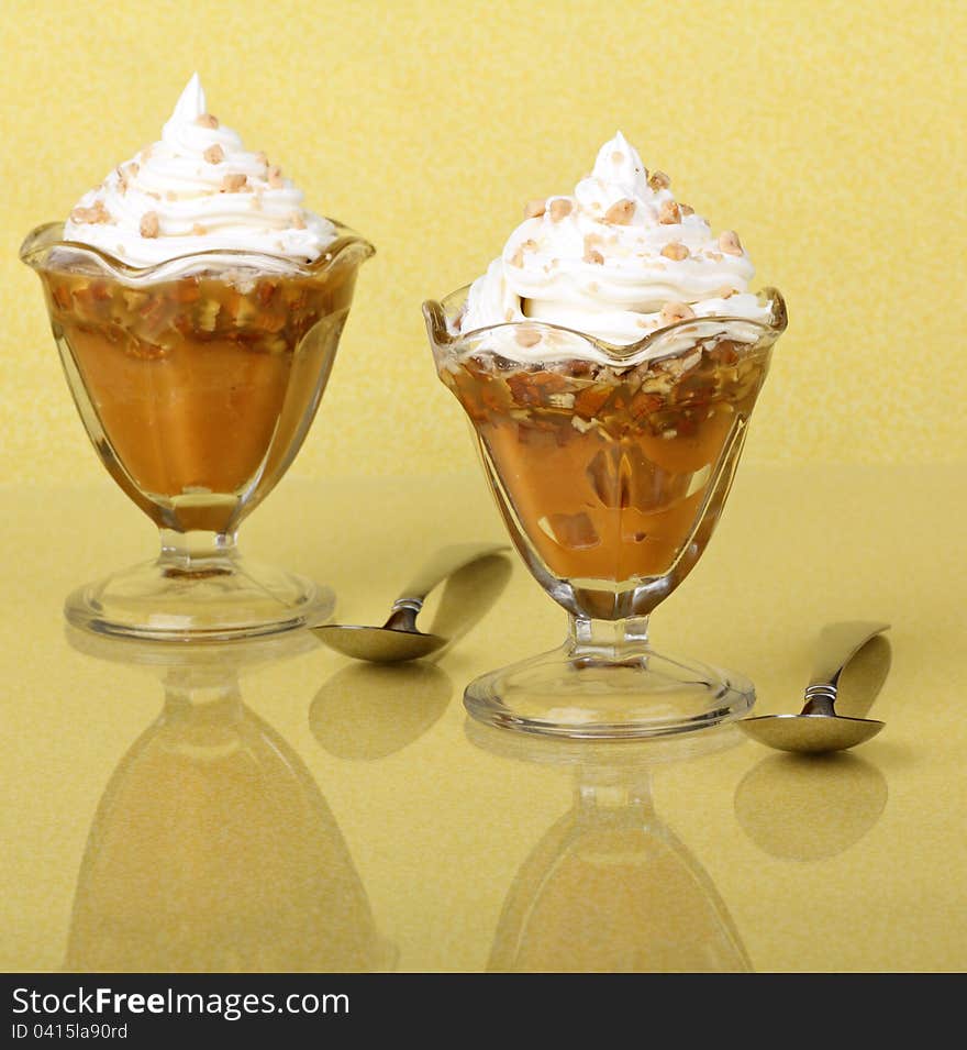 Butterscotch pudding dessert on a yellow background with a reflection