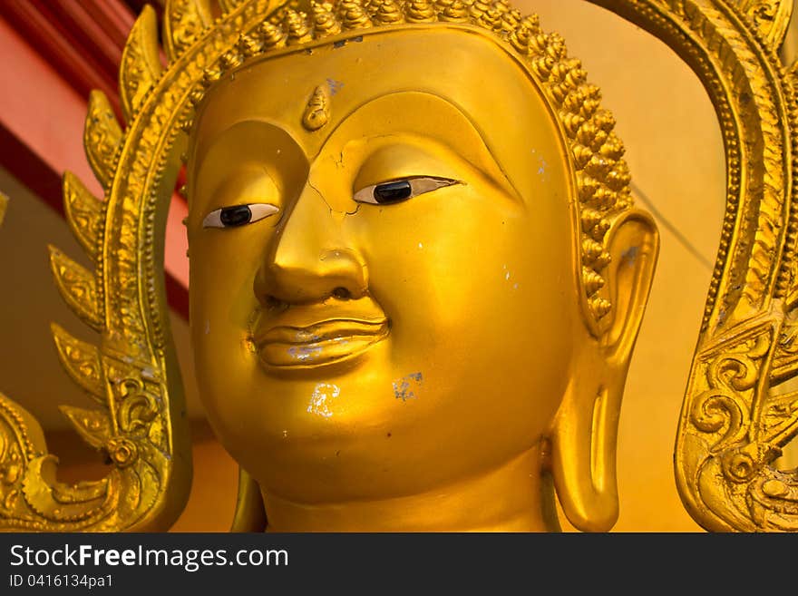 Buddha face close-up golden. Buddha face close-up golden