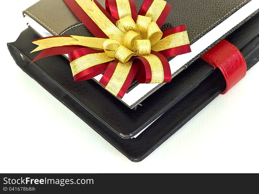 Notebook with crimson and gold ribbon.