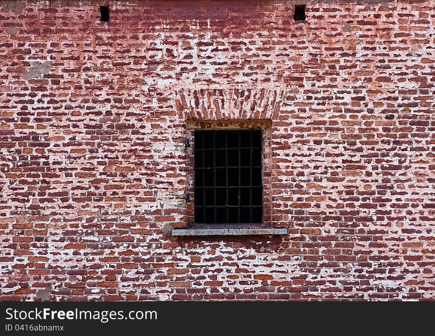 Window with bars in the old brick wall. Window with bars in the old brick wall