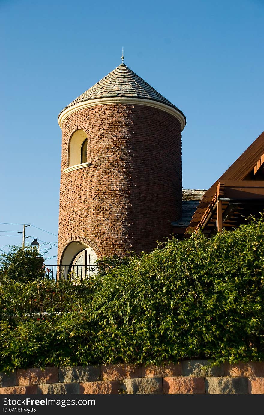 Tower portion of vineyard building. Brick tower with greenery. Tower portion of vineyard building. Brick tower with greenery.