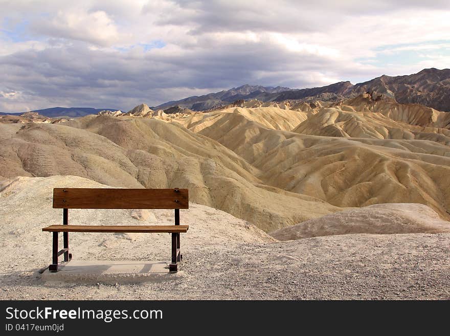 A bench waiting for someone to sit on it at Death Valley National Park in California . A bench waiting for someone to sit on it at Death Valley National Park in California .