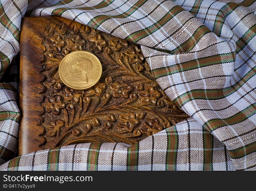 Krugerrand Sitting On A Handcarved Wood Box