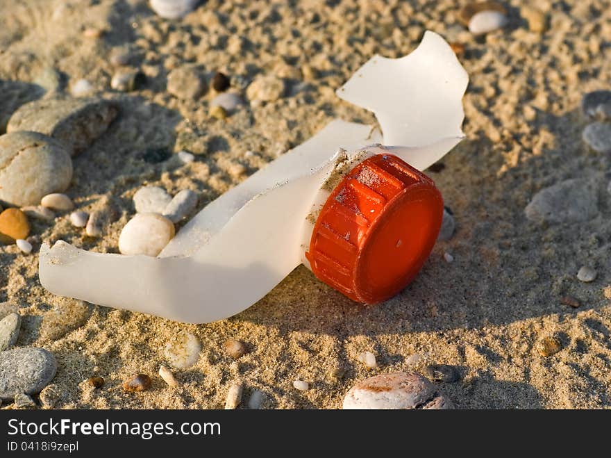 Fragment of plastic container with a red cap