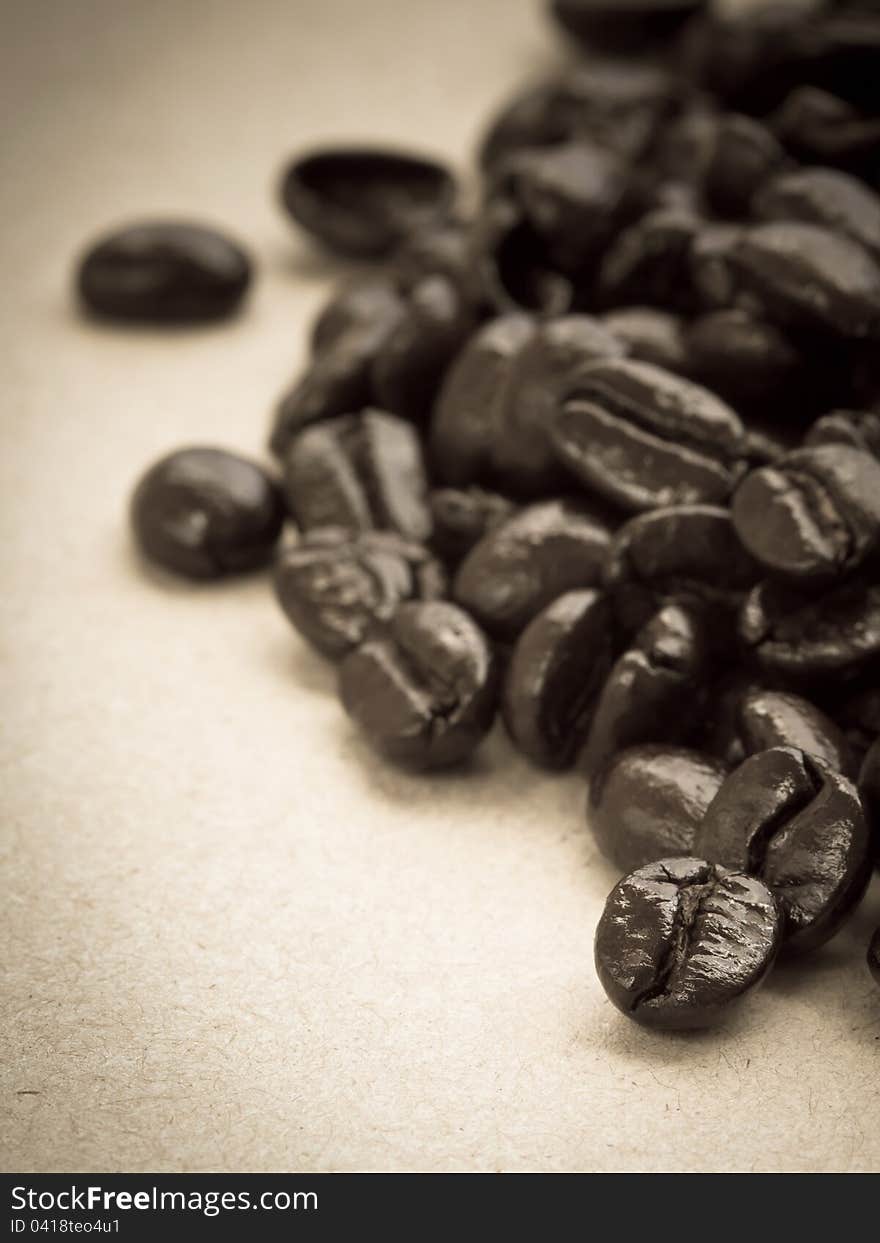 Coffee beans on cardboard, in sepia