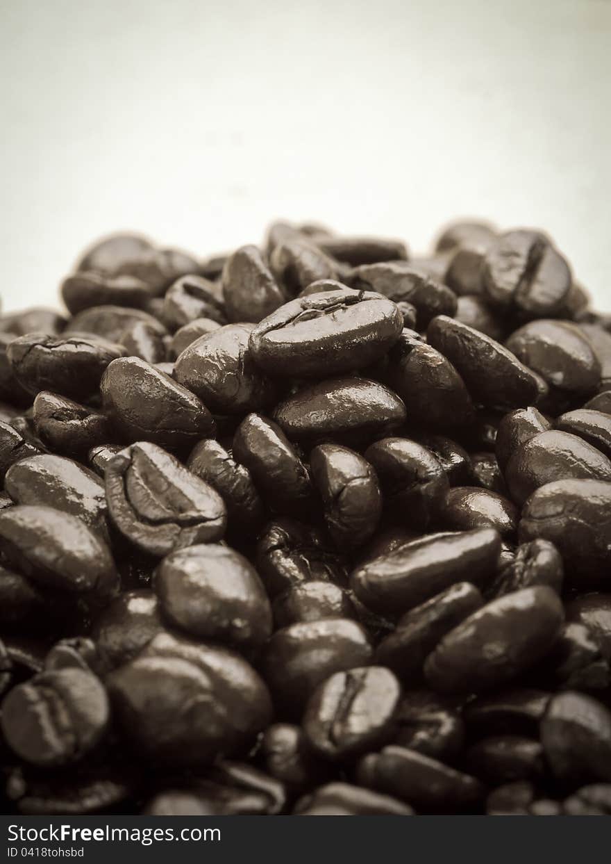 Coffee beans on cardboard, in sepia