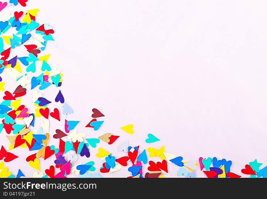 Confetti hearts set against a white background with copy space. Confetti hearts set against a white background with copy space.