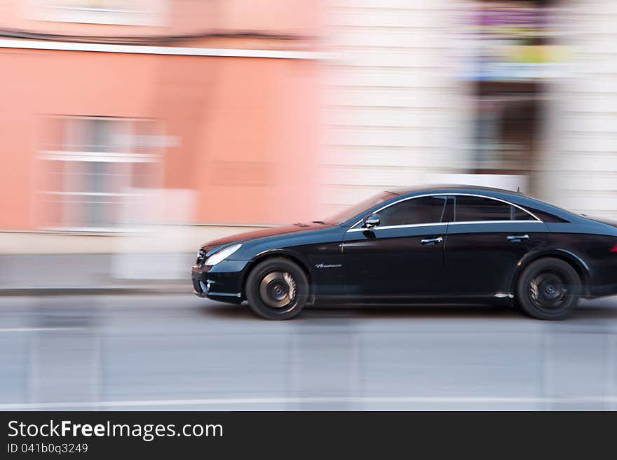 Panning image of a moving car. Panning image of a moving car