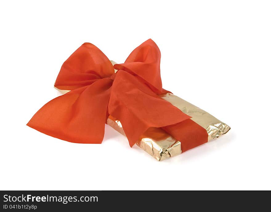 Gold wrapping is bandaged  by a red ribbon