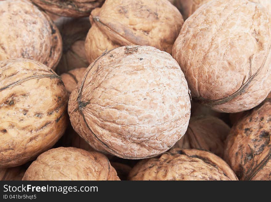 Close up of scattered walnuts. Background.