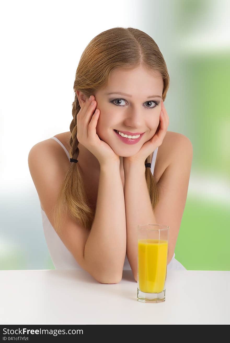 Portrait of beautiful happy cheerful girl with orange juice