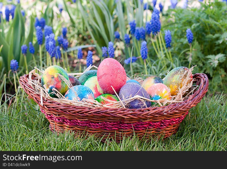 Easter eggs in  brown pannie on the grass