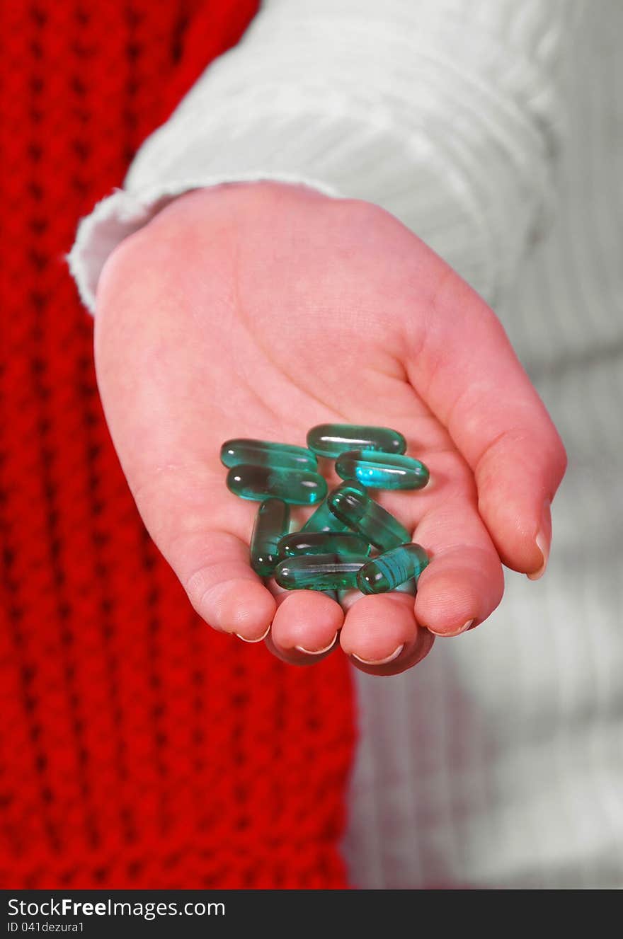 Female hand with medicine pills on white. Female hand with medicine pills on white